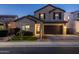 Two-story home with a brown garage door and landscaping at 18402 N 65Th Pl, Phoenix, AZ 85054