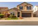 Two-story home with landscaping and a brown garage door at 18402 N 65Th Pl, Phoenix, AZ 85054