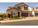 Two-story home with landscaping and a brown garage door at 18402 N 65Th Pl, Phoenix, AZ 85054