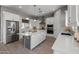 Modern kitchen with white cabinets, large island, stainless steel appliances, and ample counter space at 18402 N 65Th Pl, Phoenix, AZ 85054