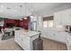 Modern kitchen with white cabinets, large island, and stainless steel appliances at 18402 N 65Th Pl, Phoenix, AZ 85054
