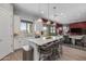Modern kitchen with white cabinets, large island, stainless steel appliances, and open concept to living area at 18402 N 65Th Pl, Phoenix, AZ 85054
