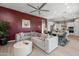 Open living area with sectional sofa and views of kitchen and backyard pool at 18402 N 65Th Pl, Phoenix, AZ 85054