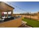 Enjoy the sunset from this outdoor kitchen area with string lights at 18402 N 65Th Pl, Phoenix, AZ 85054