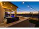 Summer kitchen with built-in grill and bar stools, adjacent to the pool at 18402 N 65Th Pl, Phoenix, AZ 85054
