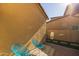 Small patio with two teal chairs and artificial turf at 18402 N 65Th Pl, Phoenix, AZ 85054