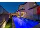 Inviting backyard pool with water features at night at 18402 N 65Th Pl, Phoenix, AZ 85054