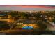 Aerial view of home with a sparkling pool in the backyard under a colorful twilight sky at 2011 W Cambridge Ave, Phoenix, AZ 85009