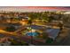 The aerial view highlights the backyard swimming pool and neighborhood landscape at twilight at 2011 W Cambridge Ave, Phoenix, AZ 85009