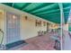 Cozy back patio with a tiled floor, seating, and a unique green ceiling at 2011 W Cambridge Ave, Phoenix, AZ 85009