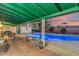 Comfortable back patio featuring a tiled floor and seating next to the pool at 2011 W Cambridge Ave, Phoenix, AZ 85009