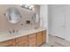 Bathroom features dual sinks, wood cabinets, and modern fixtures at 2011 W Cambridge Ave, Phoenix, AZ 85009