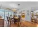A well-lit dining room features hardwood floors, a wooden table set, and a chandelier above at 2011 W Cambridge Ave, Phoenix, AZ 85009