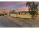 A single story home with a side garage and a well-lit window at 2011 W Cambridge Ave, Phoenix, AZ 85009
