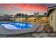 Backyard view with a sparkling pool and covered patio, ideal for outdoor gatherings and relaxation at 2011 W Cambridge Ave, Phoenix, AZ 85009