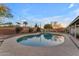 Gorgeous pool surrounded by lush landscaping and a red brick fence at 2011 W Cambridge Ave, Phoenix, AZ 85009
