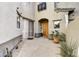 Private entryway with a wooden door and potted plants at 20802 N Grayhawk Dr # 1175, Scottsdale, AZ 85255