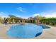 Community pool with lounge chairs and a shaded pergola at 20802 N Grayhawk Dr # 1175, Scottsdale, AZ 85255