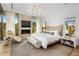 Main bedroom with fireplace, large windows, and sitting area at 27951 N 96Th Pl, Scottsdale, AZ 85262