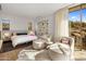 Spacious bedroom with a comfortable bed and seating area at 27951 N 96Th Pl, Scottsdale, AZ 85262