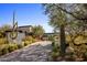 Long driveway leading to a modern home with desert landscaping at 27951 N 96Th Pl, Scottsdale, AZ 85262