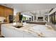 Open kitchen with marble island and a view into the living room at 27951 N 96Th Pl, Scottsdale, AZ 85262