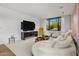 Modern living room featuring a large TV and comfortable seating at 27951 N 96Th Pl, Scottsdale, AZ 85262