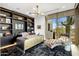 Home office with built-in shelving, large window, and chaise lounge at 27951 N 96Th Pl, Scottsdale, AZ 85262