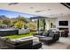 Relaxing patio with fire pit, seating, and pool views at 27951 N 96Th Pl, Scottsdale, AZ 85262