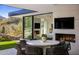 Outdoor patio with fireplace, dining area, and mountain views at 27951 N 96Th Pl, Scottsdale, AZ 85262