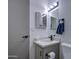 Bathroom vanity featuring modern lighting, granite countertop, a matte black faucet, and black towel rack at 3104 E Broadway Rd # 16, Mesa, AZ 85204
