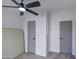 Bedroom featuring a ceiling fan and two interior doors with carpet flooring at 3104 E Broadway Rd # 16, Mesa, AZ 85204