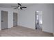 Bedroom featuring neutral carpet, and ensuite bathroom and walk-in closets at 3104 E Broadway Rd # 16, Mesa, AZ 85204