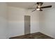 Bright bedroom with a gray interior door and wood floors at 3104 E Broadway Rd # 16, Mesa, AZ 85204