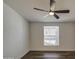 Bright bedroom features a ceiling fan, wood floors, and a window for natural light at 3104 E Broadway Rd # 16, Mesa, AZ 85204