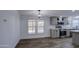 Bright dining room features wood floors, modern light fixture, and white walls at 3104 E Broadway Rd # 16, Mesa, AZ 85204
