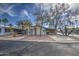 Charming single-story home featuring mature trees, a gravel front yard, and an attached carport at 3104 E Broadway Rd # 16, Mesa, AZ 85204