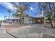 Inviting single-story home with mature landscaping, a gravel front yard, and convenient carport parking at 3104 E Broadway Rd # 16, Mesa, AZ 85204