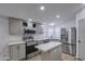Charming kitchen features stainless steel appliances and white stone countertops with an island at 3104 E Broadway Rd # 16, Mesa, AZ 85204