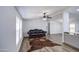 Bright living room features wood floors, leather sofa, and modern ceiling fan at 3104 E Broadway Rd # 16, Mesa, AZ 85204