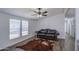 Inviting living room with wood floors, a ceiling fan, and natural light from windows at 3104 E Broadway Rd # 16, Mesa, AZ 85204