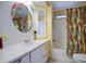 Bright bathroom featuring a stylish mirror, single sink vanity and a shower with colorful curtain at 3104 E Broadway Rd # 4, Mesa, AZ 85204