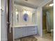 Bathroom vanity with mirror and storage cabinets, leading to shower and toilet at 3104 E Broadway Rd # 4, Mesa, AZ 85204