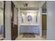 Bathroom featuring a vanity with mirrors and storage, plus neutral tile flooring at 3104 E Broadway Rd # 4, Mesa, AZ 85204