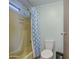 Clean bathroom featuring a shower with curtain, toilet, and storage at 3104 E Broadway Rd # 4, Mesa, AZ 85204