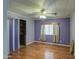 Bedroom with wood look floors, window with blinds and curtains, and closet with sliding door at 3104 E Broadway Rd # 4, Mesa, AZ 85204