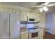 White appliances stand out in this kitchen that features wooden countertops, and ample overhead cabinets for storage at 3104 E Broadway Rd # 4, Mesa, AZ 85204
