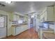 Efficient kitchen with wooden counters, white cabinetry and appliances, and wood-look flooring providing ample workspace at 3104 E Broadway Rd # 4, Mesa, AZ 85204