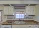 A well-lit kitchen sink area featuring wood counters, and white tiled backsplash with ample counter space at 3104 E Broadway Rd # 4, Mesa, AZ 85204