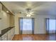Living room with wood look floors, window with blinds and curtains, and built in cabinetry at 3104 E Broadway Rd # 4, Mesa, AZ 85204